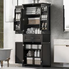 a bathroom cabinet with towels and toiletries on it in front of a bathtub