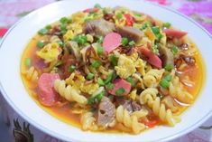 a white plate topped with pasta and vegetables