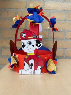 a paper basket with a fireman dog on it