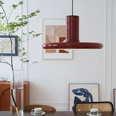 a dining room table with two cups and saucers on it