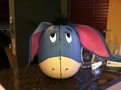 a blue and pink elephant pumpkin sitting on top of a counter