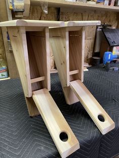 two unfinished wooden tables with holes in them