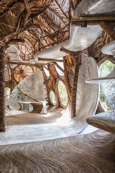 the inside of a building with trees and benches