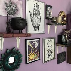 there are many pictures on the wall with hand prints and other items in front of them