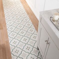 a bathroom with a white sink and tiled floor