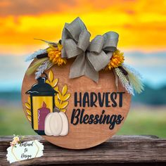 a wooden sign that says harvest blessing with a lantern and sunflowers on it