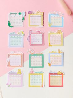 the calendar stickers have been placed on top of a pink and white tablecloth