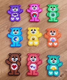 six teddy bears made out of perler beads on a wooden floor, each with different colors and shapes