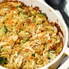 a casserole dish with broccoli, carrots and chicken in it