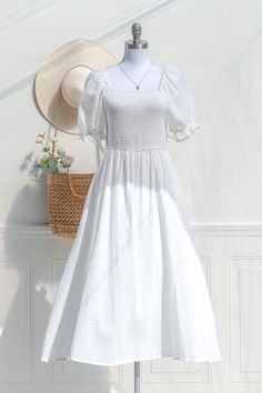 A classically romantic style, the feminine Lily of the Valley Dress is a dream in checked white cotton, with a comfortable smocked elastic bodice and tea-length skirt. Perfect for a picnic in the park, a day spent frolicking with friends, or just for lounging in with a cup of tea and your favorite novel. . Details: S: Bust 32"-38", Waist 26"-34", Length 47" M: Bust 34"-40", Waist 28"-36", Length 48" L: Bust 36"-44", Waist 32"-40", Length 49" Skirt Length Waist to Hem: 35" Lined Skirt / Unlined B Summer Prairie Dress With Smocked Bodice For Gatherings, White Prairie Dress For Summer Garden Party, Summer Cottagecore Prairie Dress For Gatherings, White Pastoral Prairie Dress For Summer, White Pastoral Prairie Dress For Spring, Summer Prairie Dress With Smocked Bodice, Feminine Summer Prairie Dress With Smocked Bodice, Summer White Prairie Dress With Empire Waist, Cottagecore Smocked Dress For Garden Party