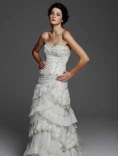 a woman in a wedding dress posing for a photo