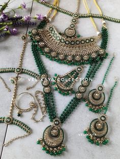 Complete Emerald green bridal set for Indian Pakistani weddings with beautiful champagne stones. Plating is antique gold. Superior craftsmanship. Each and every piece in this set has been made with utmost care and perfection. This complete bridal set includes: - Choker Necklace - Long Necklace (Length-40cm) - Earrings (Length-7.5cm; Width-4.5cm; Weight-30gm each) - Mathapatti  - Pasa / Side Tikka - Nose Ring / Nath (Weight-18gm) - Hathphool / Hathpanja / Hand Jewelry / Hand Harness All our sets