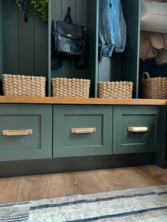 a bench with baskets on it in front of some closets and coat rackes