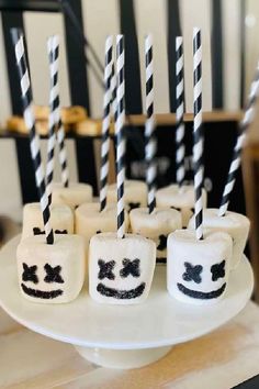 marshmallows decorated with black and white striped sticks