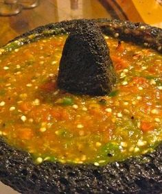 a bowl filled with soup sitting on top of a table