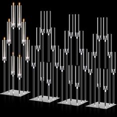 several clear candles are lined up in the shape of tubes and poles with lights on them