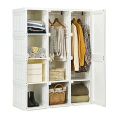 a white closet filled with lots of clothes and baskets on top of it's shelves