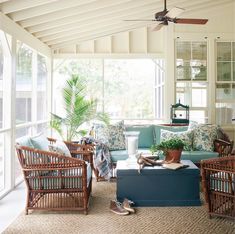 a living room filled with lots of furniture and plants on top of a coffee table