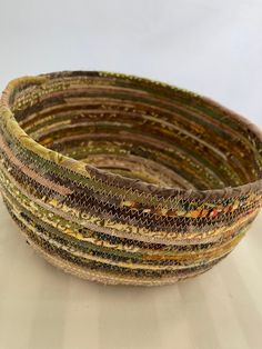 a close up of a woven basket on a white tablecloth with lines in the middle