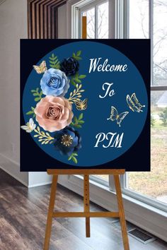 an easel with a welcome sign on it in front of a window that reads, welcome to psm