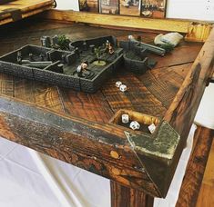 a wooden table topped with lots of different types of items on top of each other