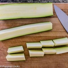 there is a knife and some cut up vegetables on the cutting board