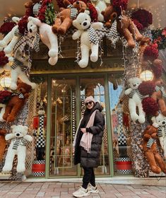 a woman standing in front of a teddy bear store