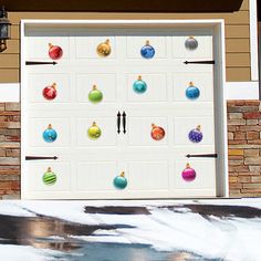 a white garage door decorated with christmas ornaments