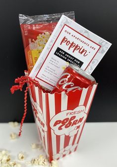 the popcorn bag is filled with movie tickets and popcorn kernels as if it were in a box