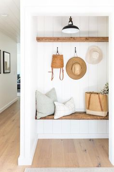 the entryway is clean and organized with hats, bags, and purses on display