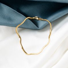 Our 14K Gold Snake Chain Bracelet is the epitome of sleek design and modern luxury. This handcrafted piece, with its distinctive flat snake chain, offers a smooth and comfortable fit, making it perfect for daily wear or special occasions. The high-quality 14K gold construction not only imparts lasting durability but also an undeniably elegant aesthetic. Available in various widths and lengths, this bracelet can be personalized to your exact preference for a snug or more relaxed fit. Key Features Flat Snake Chain, Gold Snake Chain, Snake Chain Bracelets, Elegant Aesthetic, Gold Flats, Gold Snake, Classic Gold, Exquisite Jewelry, Snake Chain