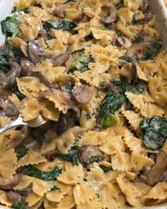 a casserole dish with mushrooms, spinach and cheese in it is ready to be eaten