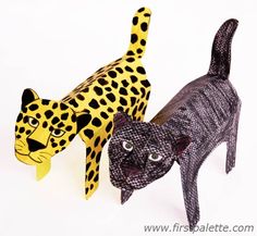 two black and yellow cat figurines one is leopard, the other is cheetah