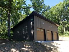 two garages in the middle of a wooded area