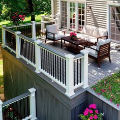 a deck with furniture and flowers on it