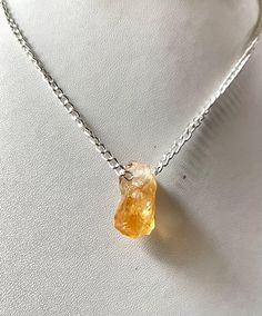 PRODUCT DETAILS Citrine Raw Pendant& Necklace  Quality- AAA+ Stone Size:- 20x10 MM 925 Sterling Silver Citrine Pendant. Raw Yellow Citrine Pendant. COUNTRY OF ORIGIN ~ BRAZIL  FREE GEMSTONE GIFT ON EVERY PURCHASE  HEALING PROPERTIES OF Raw Citrine:- Citrine is the stunning transparent, pale yellow to red-orange, to orange-yellow,  to brownish orange variety of crystalline quartz. Many believed it was a gift from the sun which gives us a warm color to brighten up our mood.  Though it's not rare, Positive Characteristics, Conscious Awareness, Raw Citrine, Citrine Pendant, Citrine Necklace, Yellow Citrine, Natural Citrine, Necklace Gemstone, Necklace Women