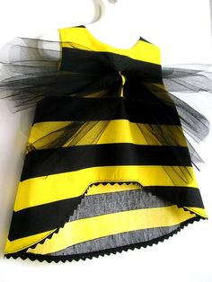 a yellow and black dress hanging on the wall