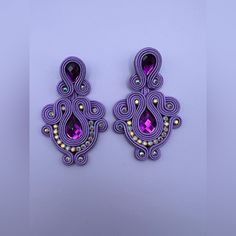 pair of purple earrings on white background