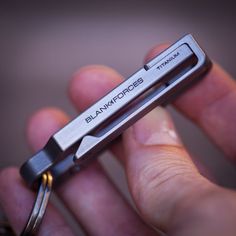 a close up of a person holding a small metal object in their hand with the word bankforces on it