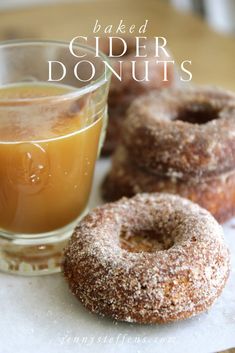 glazed cider donuts next to a glass of orange juice