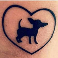 an image of a tattoo on someone's leg that has a dog in the shape of a heart