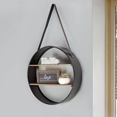 a wall mounted shelf with two shelves and a chalkboard sign on the bottom, in front of a window