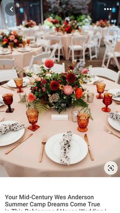 the table is set with flowers and place settings