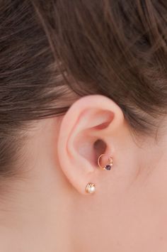 a close up of a person's ear with an ear piercing