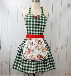 a green and white checkered apron on a mannequin with a red bow