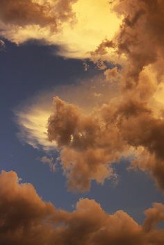 an airplane is flying in the sky with clouds