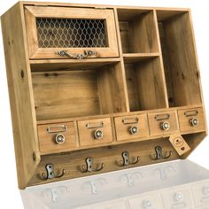 a wooden cabinet with several drawers and hooks on the bottom, one drawer is open