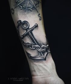 a black and white anchor tattoo on the arm