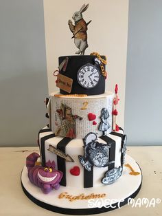 a three tiered cake decorated with cartoon characters