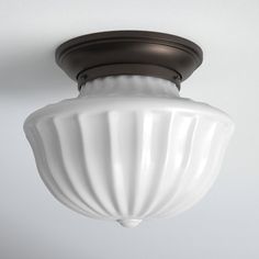 a white light fixture hanging from the ceiling